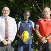 Bishop Druitt College student Kaman Malou will be representing NSW/ACT in the All Nations Cup to be played in Coffs Harbour. Kaman is pictured with school principal Alan Ball and AFL Northern NSW regional manager Rb McKelvie. Photo: Brad Palmer - Bishop D