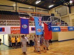 Guam, Fiji, and Samoa flags being raised during ceremony